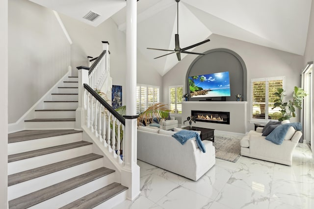 96 Garnet Pl, Destin, FL 32541 - living area with high vaulted ceiling, healthy amount of natural light, ceiling fan, a glass covered fireplace, and stairway