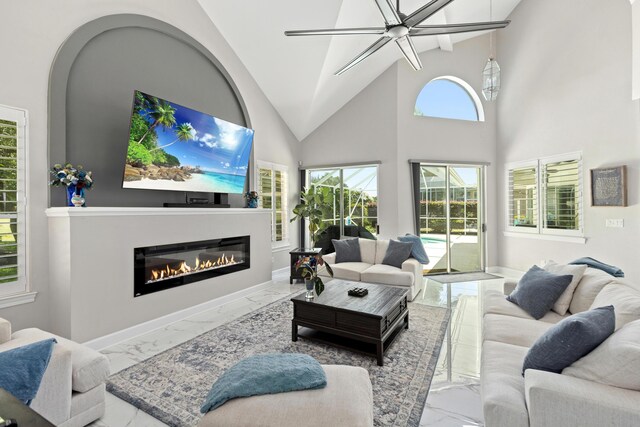 96 Garnet Pl, Destin, FL 32541 - living area with marble finish floors, a glass covered fireplace, and high vaulted ceiling