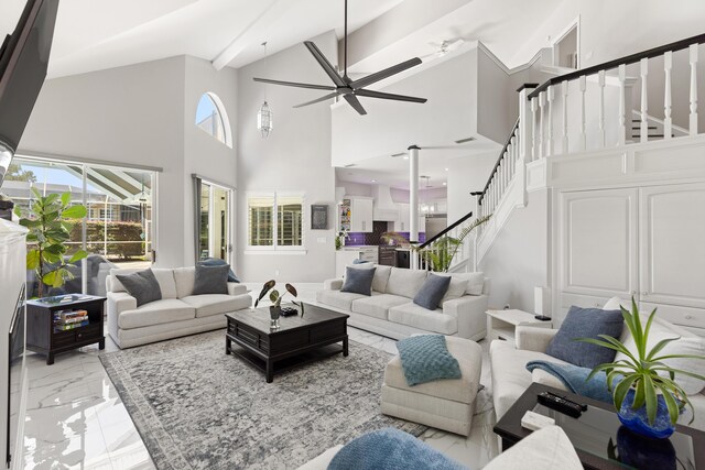 96 Garnet Pl, Destin, FL 32541 - living area featuring ceiling fan, a towering ceiling, light marble finish flooring, and stairway