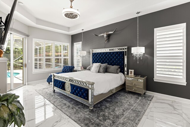 96 Garnet Pl, Destin, FL 32541 - bedroom featuring marble look tiles, access to exterior, a chandelier, and a raised ceiling