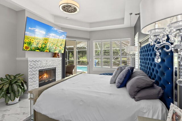 96 Garnet Pl, Destin, FL 32541 - bedroom featuring marble look tile flooring, a fireplace, and access to outside