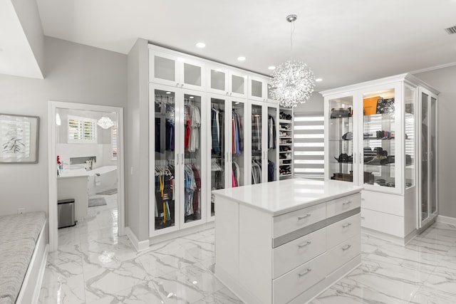 96 Garnet Pl, Destin, FL 32541 - walk in closet featuring light marble finish floors and a chandelier