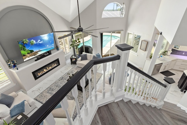 96 Garnet Pl, Destin, FL 32541 - staircase with high vaulted ceiling, a glass covered fireplace, and ceiling fan