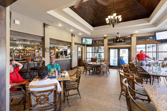 96 Garnet Pl, Destin, FL 32541 - dining room with a tray ceiling, tile patterned flooring, plenty of natural light, recessed lighting, and a chandelier