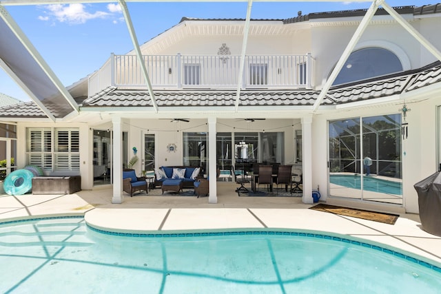 96 Garnet Pl, Destin, FL 32541 - back of house with a balcony, a tiled roof, outdoor lounge area, a ceiling fan, and an outdoor pool