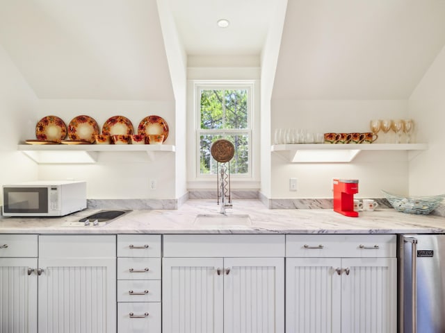16 Beachberry Ln, Santa Rosa Beach, FL 32459 - kitchen featuring open shelves, white microwave, white cabinets, and light stone counters