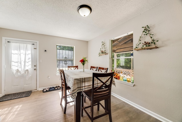 965 B St, Crestview, FL 32536 - dining area featuring wood finished floors, healthy amount of natural light, and a textured ceiling