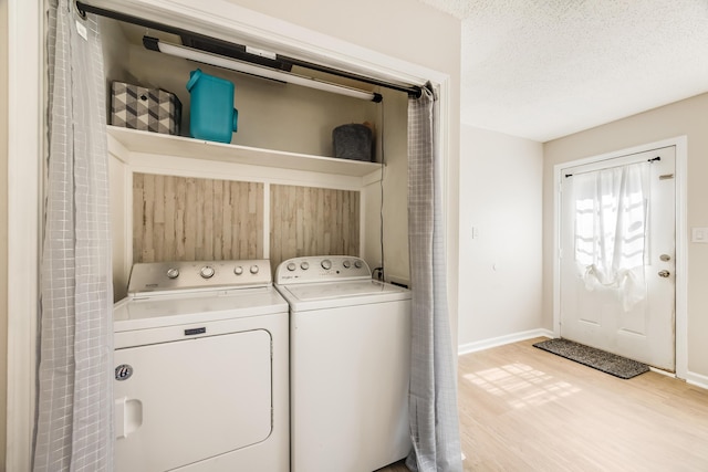 965 B St, Crestview, FL 32536 - laundry area with light wood-type flooring, washer and clothes dryer, and a textured ceiling