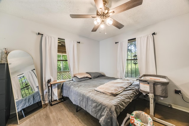 965 B St, Crestview, FL 32536 - bedroom with light wood-style floors, a textured ceiling, multiple windows, and ceiling fan