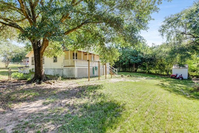 965 B St, Crestview, FL 32536 - view of yard with stairs, a storage unit, and covered porch