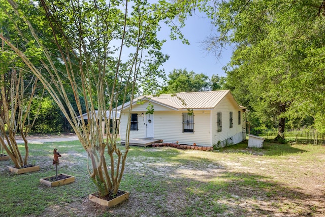 965 B St, Crestview, FL 32536 - view of front of house featuring a metal roof, crawl space, and a deck