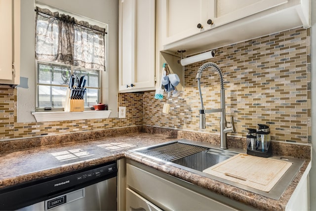 965 B St, Crestview, FL 32536 - kitchen featuring stainless steel dishwasher, backsplash, white cabinets, and dark countertops