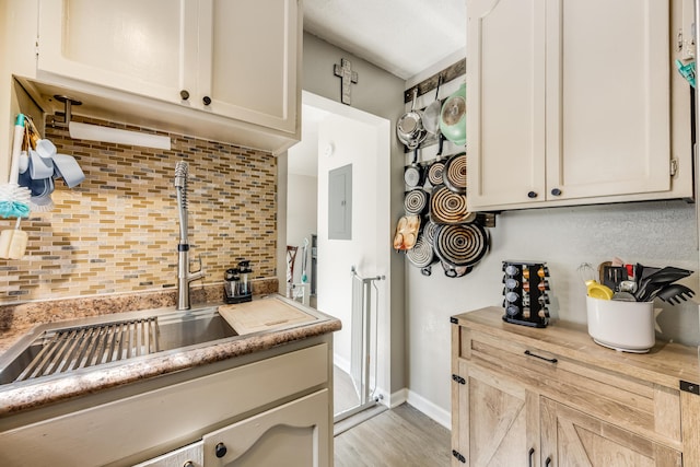 965 B St, Crestview, FL 32536 - kitchen featuring decorative backsplash, electric panel, light countertops, and wood finished floors