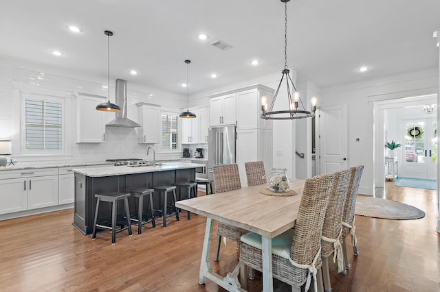 257 Matts Way, Santa Rosa Beach, FL 32459 - dining room with a chandelier, light wood-style floors, crown molding, and recessed lighting