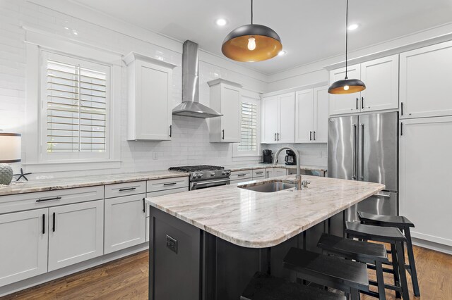 257 Matts Way, Santa Rosa Beach, FL 32459 - kitchen featuring wall chimney range hood, premium appliances, a kitchen breakfast bar, dark wood-style flooring, and white cabinetry