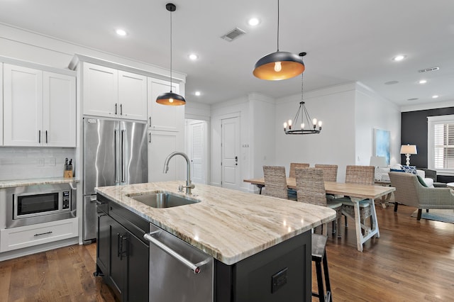 257 Matts Way, Santa Rosa Beach, FL 32459 - kitchen with stainless steel appliances, white cabinetry, crown molding, backsplash, and open floor plan