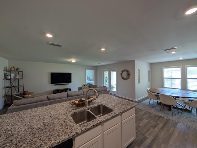 656 Hunters Ridge Rd, Defuniak Springs, FL 32433 - kitchen featuring open floor plan, light stone counters, white cabinets, dark wood finished floors, and recessed lighting