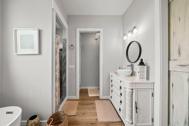 71 Childers Ln, Freeport, FL 32439 - full bath with vanity, wood finished floors, and a stall shower