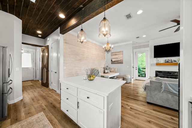 71 Childers Ln, Freeport, FL 32439 - kitchen with open floor plan, stainless steel refrigerator with ice dispenser, white cabinetry, light countertops, and a ceiling fan