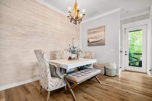 71 Childers Ln, Freeport, FL 32439 - dining area with a chandelier, wood finished floors, and wooden walls