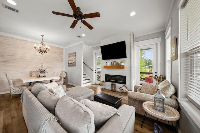 71 Childers Ln, Freeport, FL 32439 - living area with ceiling fan, wood finished floors, a chandelier, a large fireplace, and wooden walls