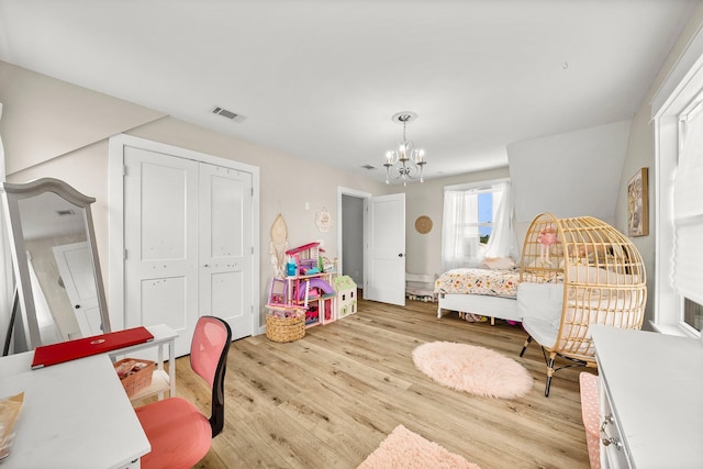 71 Childers Ln, Freeport, FL 32439 - bedroom featuring a chandelier, light wood-style floors, and a closet