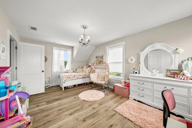 71 Childers Ln, Freeport, FL 32439 - bedroom featuring wood finished floors and a chandelier