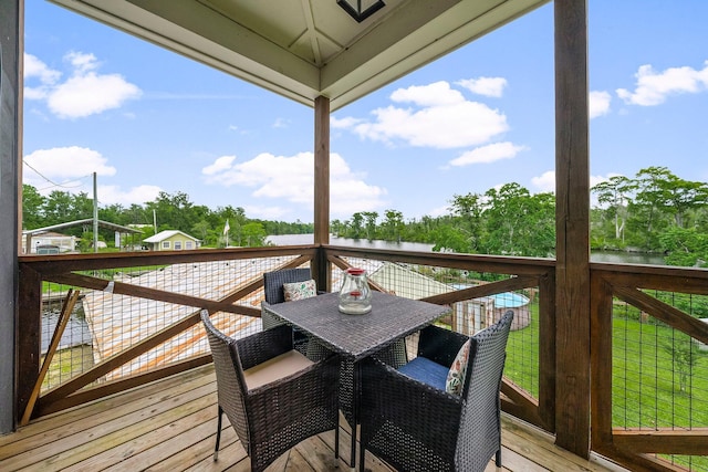 71 Childers Ln, Freeport, FL 32439 - deck featuring outdoor dining space, view of scattered trees, and a water view