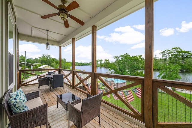 71 Childers Ln, Freeport, FL 32439 - deck with a water view, ceiling fan, outdoor dining space, and view of scattered trees