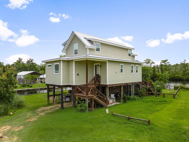 71 Childers Ln, Freeport, FL 32439 - back of property with stairway, a lawn, and a water view
