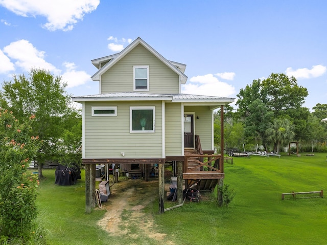 71 Childers Ln, Freeport, FL 32439 - back of property featuring a carport, driveway, a lawn, and a metal roof