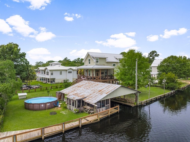 71 Childers Ln, Freeport, FL 32439 - dock featuring a water view, an outdoor pool, and a yard