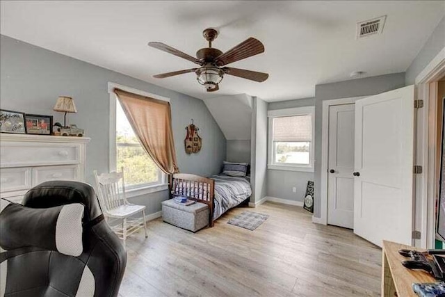 71 Childers Ln, Freeport, FL 32439 - bedroom with multiple windows, light wood-style flooring, ceiling fan, lofted ceiling, and a closet
