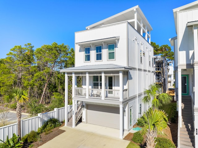 34 W Majestic Palm Dr, Inlet Beach, FL 32461 - view of front of house featuring stairs, a garage, driveway, a balcony, and covered porch