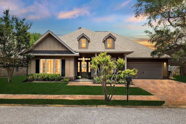 134 Mussett Bayou Ct, Santa Rosa Beach, FL 32459 - craftsman-style home featuring board and batten siding, a garage, a shingled roof, decorative driveway, and a front yard