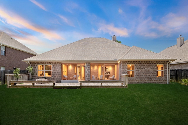 134 Mussett Bayou Ct, Santa Rosa Beach, FL 32459 - back of property at dusk with a fenced backyard, brick siding, roof with shingles, and a chimney