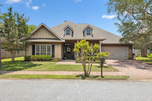 134 Mussett Bayou Ct, Santa Rosa Beach, FL 32459 - view of front of house with decorative driveway, a garage, a shingled roof, a front lawn, and board and batten siding