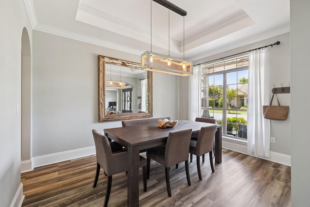 134 Mussett Bayou Ct, Santa Rosa Beach, FL 32459 - dining area featuring a raised ceiling, ornamental molding, wood finished floors, and arched walkways