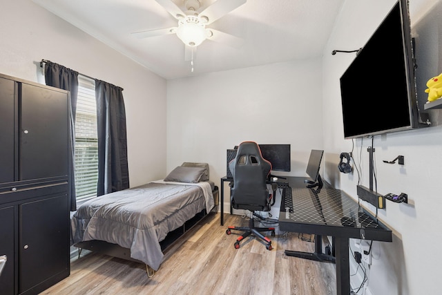 134 Mussett Bayou Ct, Santa Rosa Beach, FL 32459 - bedroom with light wood-style floors, ceiling fan, and a desk