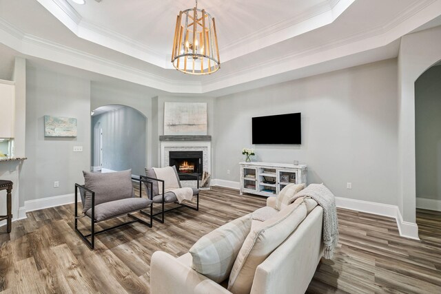 134 Mussett Bayou Ct, Santa Rosa Beach, FL 32459 - living area featuring arched walkways, a raised ceiling, dark wood-style flooring, and ornamental molding