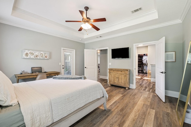 134 Mussett Bayou Ct, Santa Rosa Beach, FL 32459 - bedroom featuring a tray ceiling, ornamental molding, wood finished floors, and a ceiling fan
