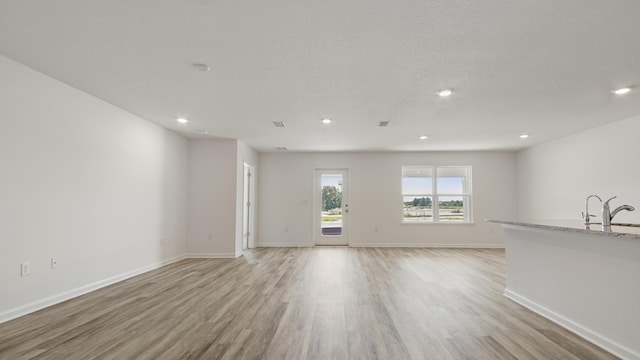 207 Eunola Ln, Freeport, FL 32439 - unfurnished living room featuring light wood-type flooring and recessed lighting