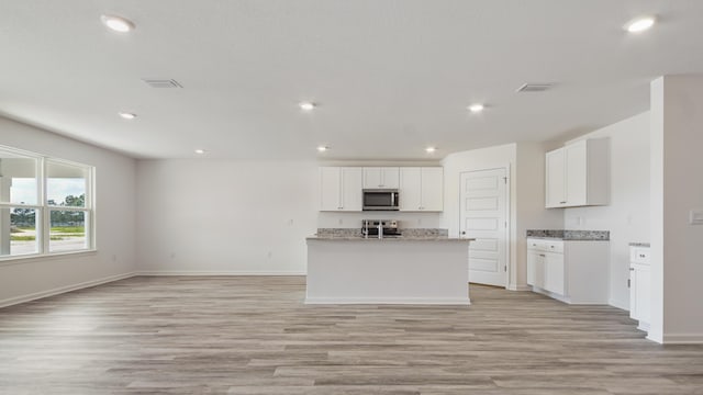 207 Eunola Ln, Freeport, FL 32439 - kitchen with stainless steel appliances, light wood-type flooring, white cabinets, open floor plan, and recessed lighting