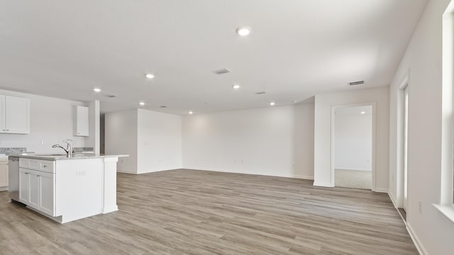 207 Eunola Ln, Freeport, FL 32439 - kitchen featuring white cabinets, dishwasher, light wood finished floors, an island with sink, and recessed lighting