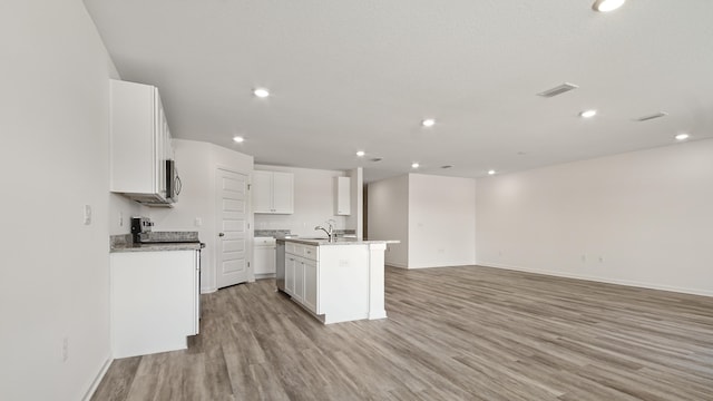 207 Eunola Ln, Freeport, FL 32439 - kitchen featuring open floor plan, light wood-type flooring, an island with sink, white cabinets, and recessed lighting