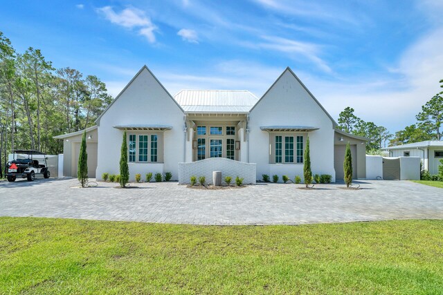34 E Surfside Dr, Santa Rosa Beach, FL 32459 - view of front of house featuring a standing seam roof, a metal roof, and stucco siding
