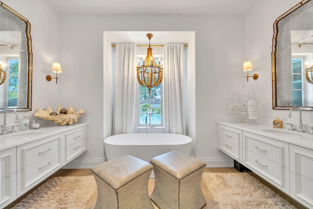 34 E Surfside Dr, Santa Rosa Beach, FL 32459 - full bath featuring wood finished floors, two vanities, a chandelier, and a soaking tub