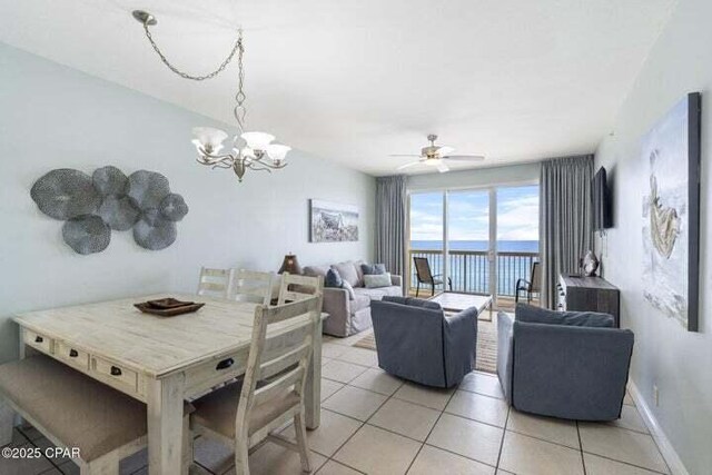 15817 Front Beach Rd # 706, Panama City Beach, FL 32413 - dining room with light tile patterned floors, a ceiling fan, and a chandelier
