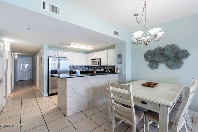 15817 Front Beach Rd # 706, Panama City Beach, FL 32413 - dining room featuring light tile patterned floors and a chandelier