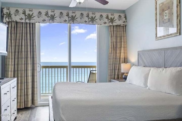 15817 Front Beach Rd # 706, Panama City Beach, FL 32413 - bedroom featuring a water view, multiple windows, wood finished floors, and ceiling fan